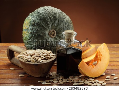 Pumpkin, pumpkin seeds in a scoop and pumpkin seeds  oil bottle