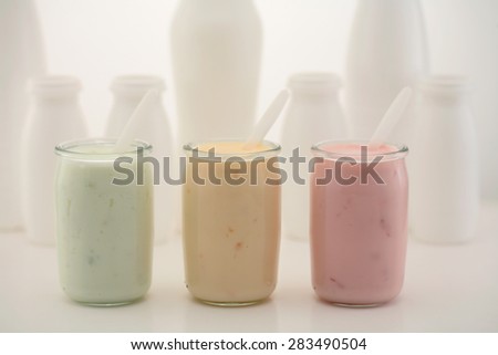 Homemade live fruit yogurt pots/ yogurt jar isolated on white background