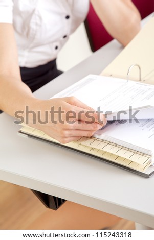 young secretary working in office with file folder
