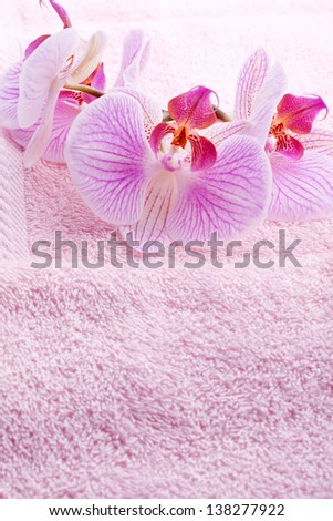 luxury wellness towel with pink orchid flower