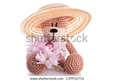 brown stuffed animal teddy bear with pink blossom