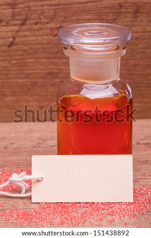 essential rose oil in a bottle with label