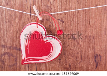 red wooden heart on lead