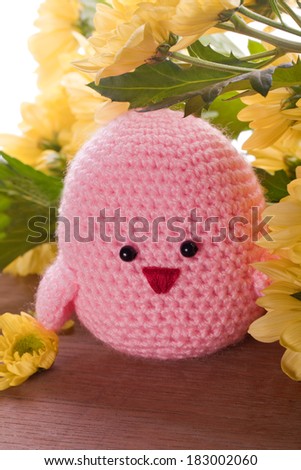 handmade chick with spring flowers as decoration