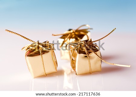 golden christmas gift boxes on blue background