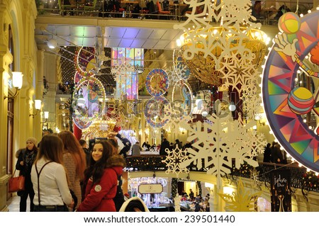 MOSCOW - DECEMBER 21: Christmas illuminations, decorations and girls walking in the GUM store on December 21, 2014 in Moscow.
