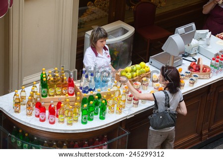 MOSCOW - JULY 29: A buyer choosing a soft drink in the GUM store on July 29, 2014 in Moscow.