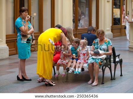 MOSCOW - JULY 29: Adults and children eating ice cream in the GUM store on July 29, 2014 in Moscow. GUM is the large store in the Kitai-gorod part of Moscow facing Red Square.