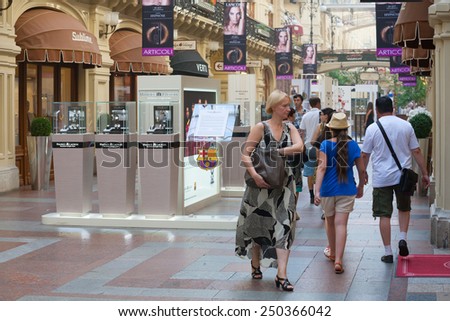 MOSCOW - JULY 29: People walking in the GUM store on July 29, 2014 in Moscow. GUM is the large store in the Kitai-gorod part of Moscow facing Red Square.