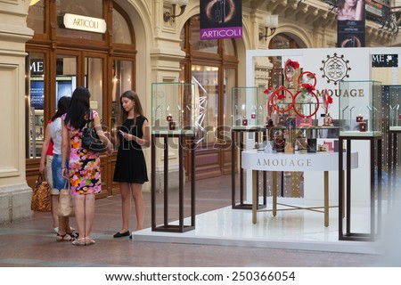 MOSCOW - JULY 29: Girls talking near the perfume department at GUM store on July 29, 2014 in Moscow. GUM is the large store in the Kitai-gorod part of Moscow facing Red Square.