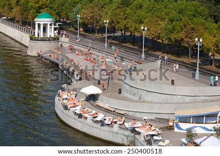 MOSCOW - JULY 31: Many people resting at Olive Beach in Gorky Park on July 31, 2014 in Moscow. Olive Beach is located on the bank of Moskva River.