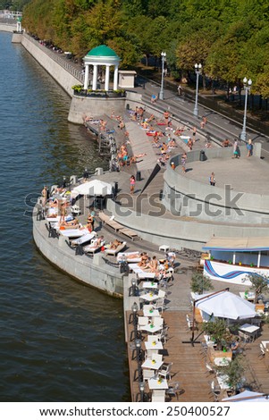 MOSCOW - JULY 31: Many people sunbathing at Olive Beach in Gorky Park on July 31, 2014 in Moscow. Olive Beach is located on the bank of Moskva River.