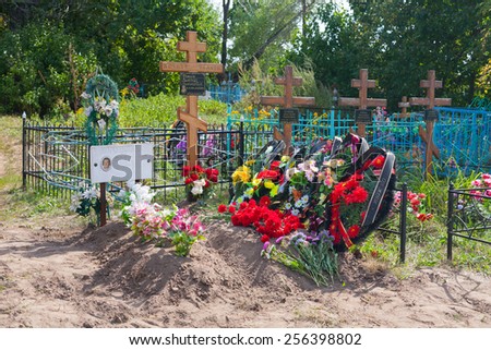 BESTUZHEVO, RUSSIA - AUGUST 26: Graves, flowers, wreaths and crosses in the cemetery on August 26, 2014 in Bestuzhevo village.
