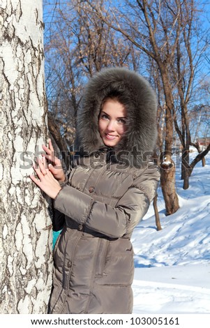 Beautiful young woman in winter clothes outdoor in forest