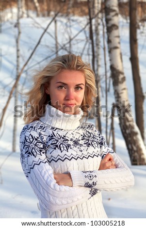 Beautiful young woman in winter clothes outdoor in forest