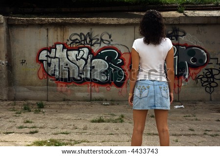 Woman looking graffiti. Samara. Russia.