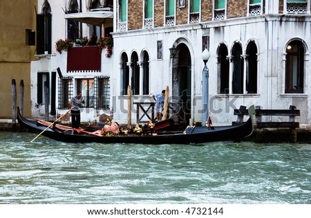 Venetian gondola and gondolier at the main canal of Venice. Italy.