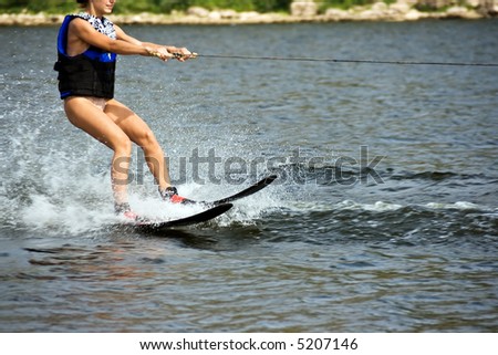 Young woman sliding on the water ski