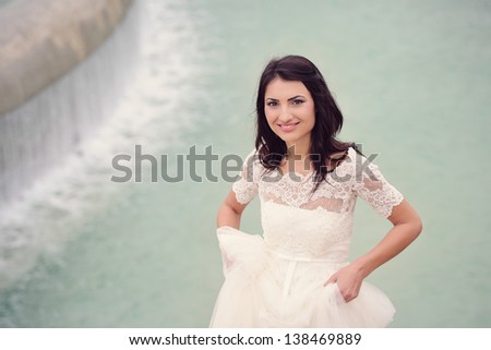 Beautiful delicate bride smiling on her wedding day in Paris