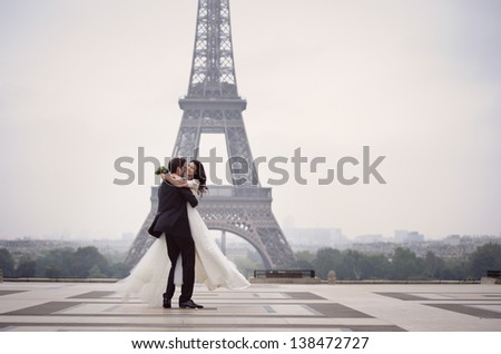 Bride And Groom Having A Romantic Moment On Their Wedding Day In Paris, In Front Of The Eiffel Tour