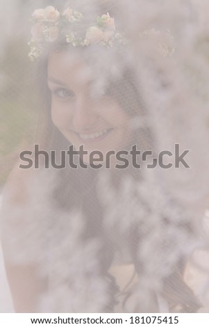 Bride smiling in a tent at a photo session in the nature
