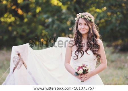 Beautiful bride dreaming, at a photo session in the nature