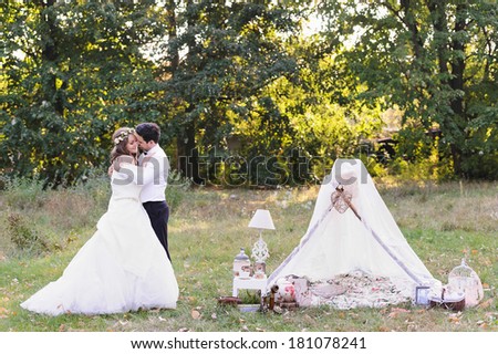 Beautiful bride and groom hugging on their wedding day, photo session in the nature