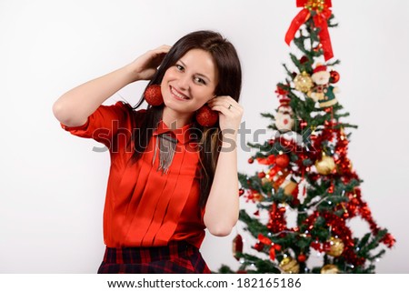 Christmas day. Young girl smiling at a photo session in a studio
