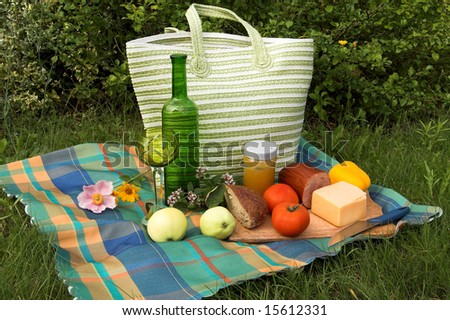 Country-style setting with wine, fruit, bread and cheese