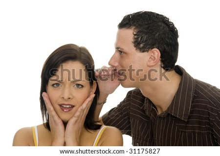 A man whispers a secret in the ear