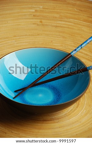 Blue bowl with chopsticks in bamboo bowl
