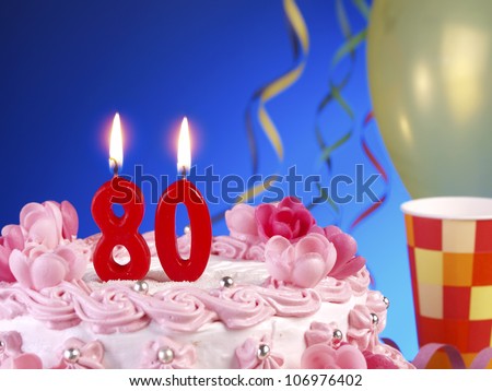 Birthday-anniversary cake with red candle showing Nr. 80