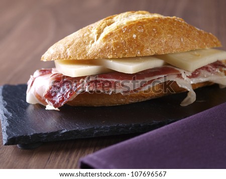 Cured ham and cheese sandwich. Typical spanish sandwich made with cured ham, cheese and baguette bread.
