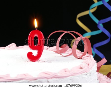 Birthday-anniversary cake with red candle showing Nr. 9