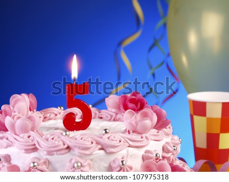 Birthday-anniversary cake with red candles showing Nr. 5