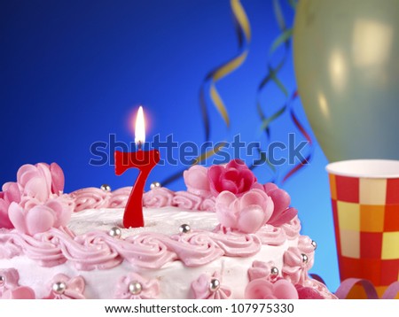 Birthday-anniversary cake with red candles showing Nr. 7