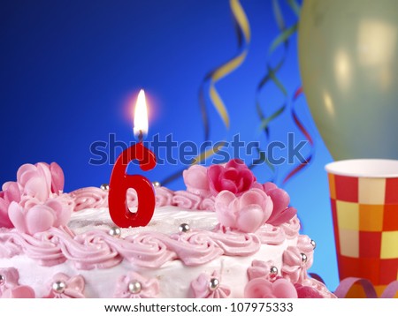 Birthday-anniversary cake with red candles showing Nr. 6