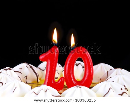Birthday-anniversary cake with red candles showing Nr. 10