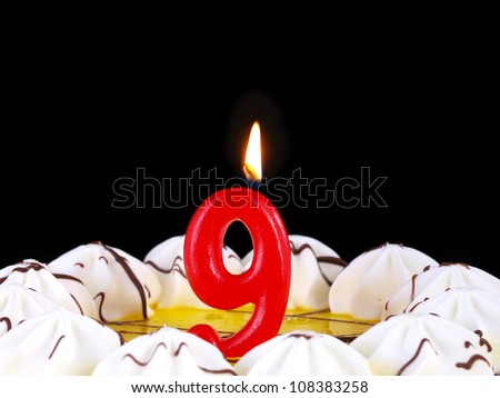 Birthday-anniversary cake with red candles showing Nr. 9