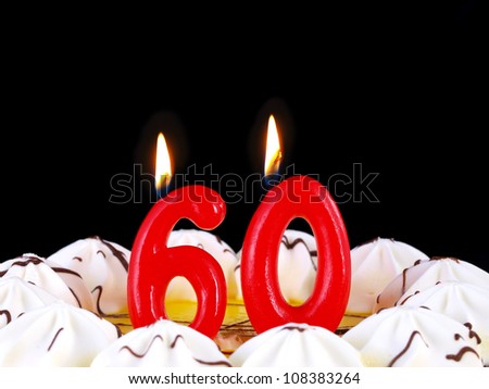 Birthday-anniversary cake with red candles showing Nr. 60