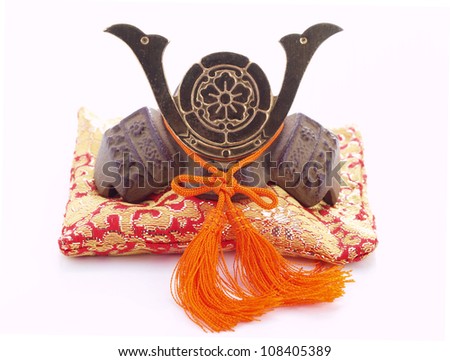 Japanese souvenir. Miniature of a samurai helmet on a pillow.
