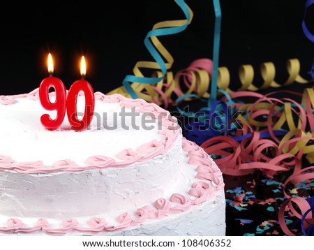 Birthday-anniversary cake with red candles showing Nr. 90