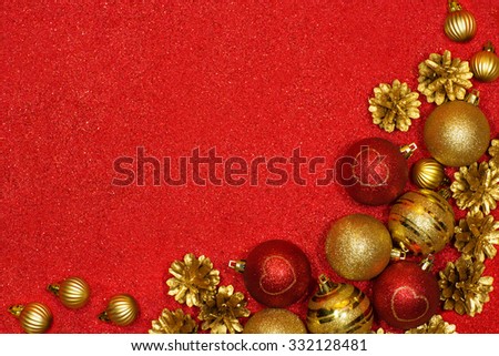Merry Christmas and Happy New Year festive background with red and gold balls and pine cones