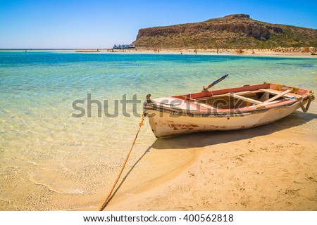 Fishing boat docked to coast on the beautiful beach of Crete, Greece