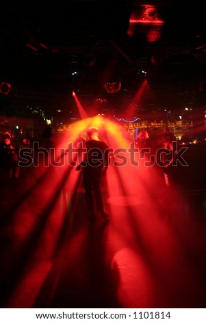 Silhouette of a dancing man between red scanner light in a disco