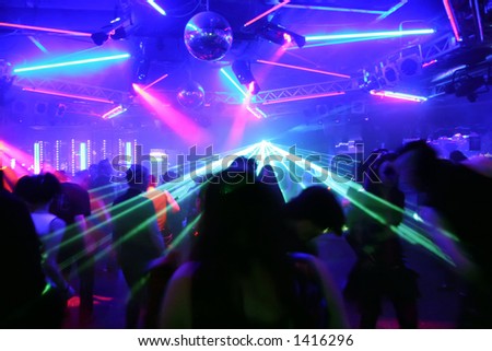 dancing people before flashing laser beams