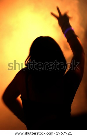 silhouette of dancing woman waving her arms
