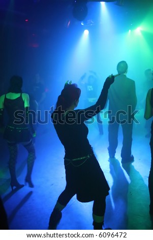 Silhouette of a dancing woman in an underground club
