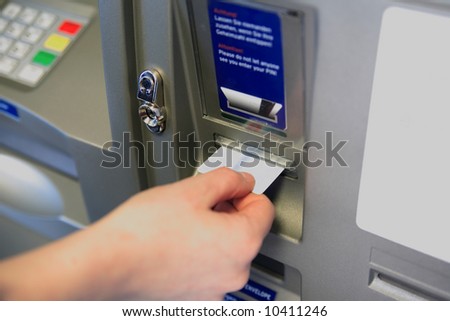 ATM Access -  Female hand inserts banking card