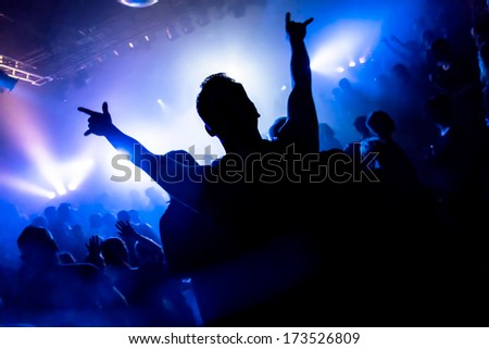 Dancing People In A Disco Raising Their Arms